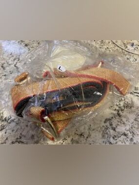 Brand new in package - never opened. Large horse halter. Gold and red.